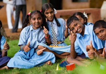 Children at an NGO school, Jan Sewa Trust, giving thumbs up